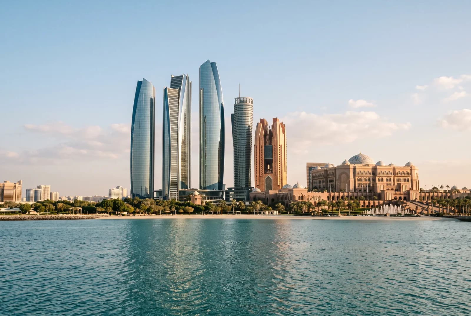 Glass towers beside a sand-colored palace with a central dome on the waterfront