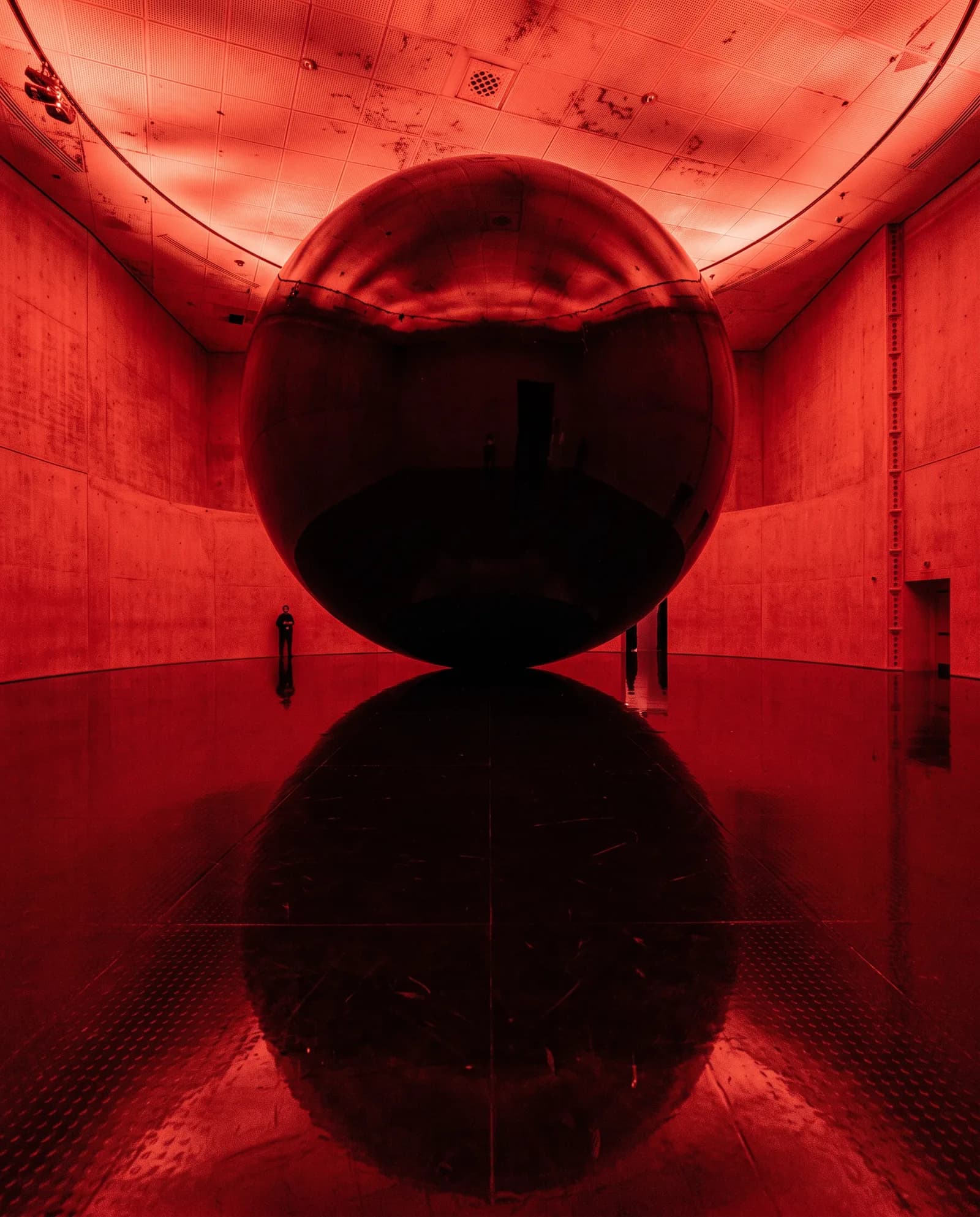 Dark sphere and its reflection in a red room